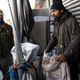 A sanitation worker talks to Neil Singh, a homeless man who has been living on Eldridge street for almost two years, as he is forced to dismantle his structure and move after receiving a notice from the city Department of Sanitation as part of Mayor Adams policy to remove homeless encampments, April 11, 2022, in the Chinatown neighborhood of New York City, New York.